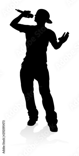 A singer pop, country music, rock star or hiphop rapper artist vocalist singing in silhouette