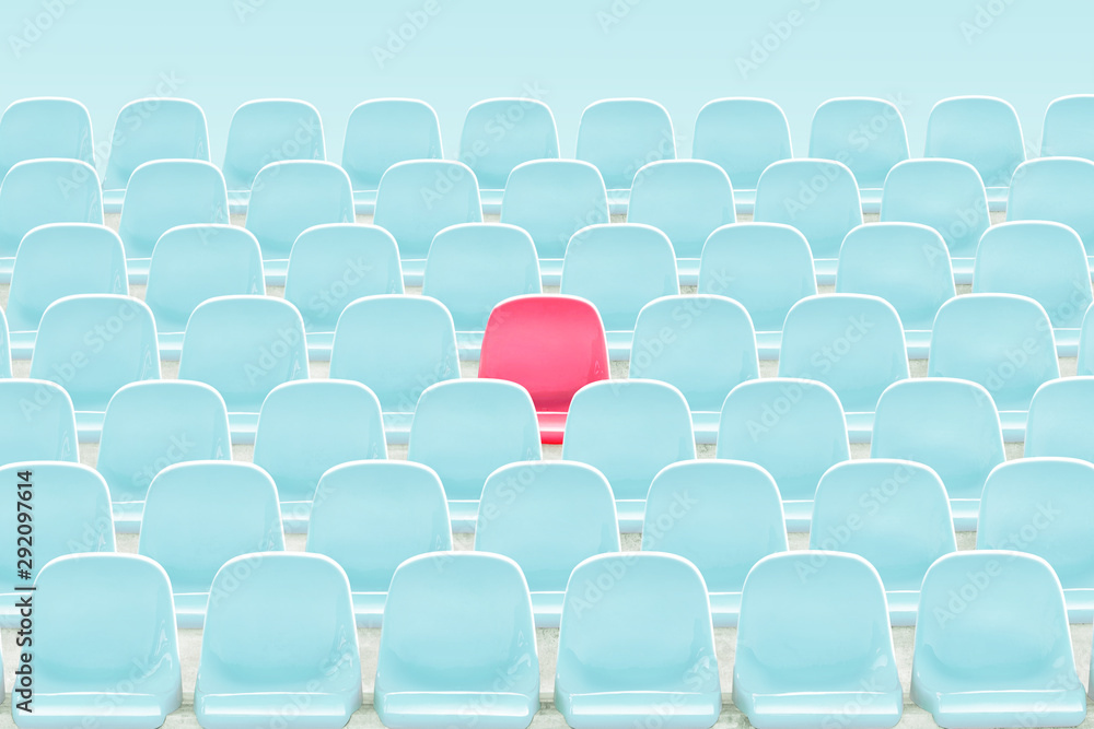 Obraz premium SInger red seat in the middle of light blue chair in stadium .
