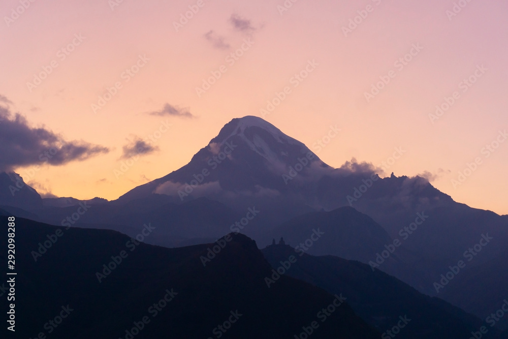 Mount Kazbek in Georgia. Mountain landscape at sunset. Nature concept