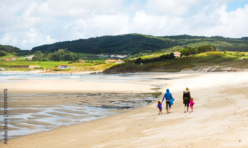 Happy young family is walking on sandy beach and ocean. Happy young family is walking on sandy beach and ocean.