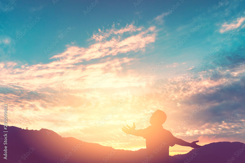 Copy space of man rise hand up on top of mountain and sunset sky abstract background. Copy space of man rise hand up on top of mountain and sunset sky abstract background.