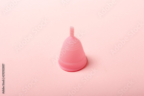 Menstrual cup on a pink background. The concept of menstruation. Flat lay, top