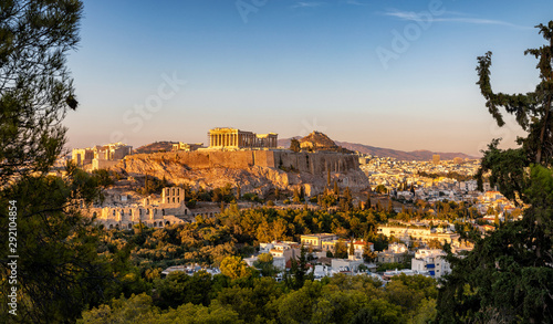 View to the Parthenon Temple at the Acropolis of Athens above the old town Plaka during sunset time, Greece