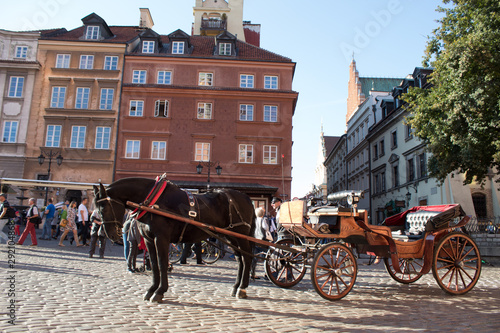  A brown horse and a royal carriage on the streets of the Warsaw Old Town.