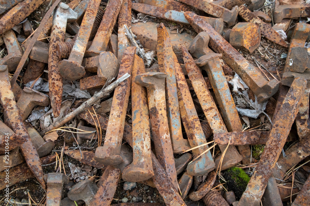 rusty railroad spikes on ground outdoors
