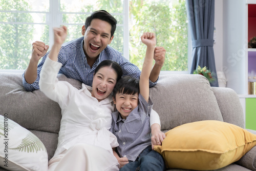 Asian family father, mother and son smiling feeling exciting together in living room, happy family concept