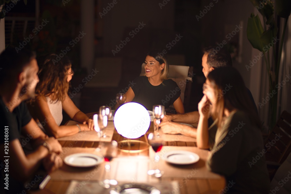 Beautiful family on dinner talking and smiling at terrace Beautiful family on dinner talking and smiling at terrace
