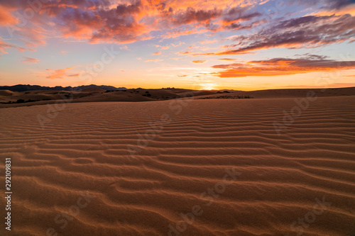 Sunset over the sand dunes in the desert