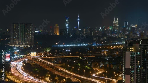 Beautiful time lapse motion, Kuala Lumpur cityscape, aerial view, night scene, vehicles moving on road or highway link to main city.