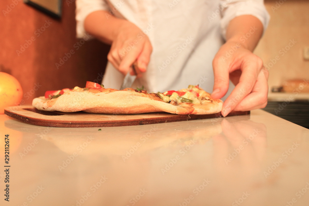 chef prepares pizza at home