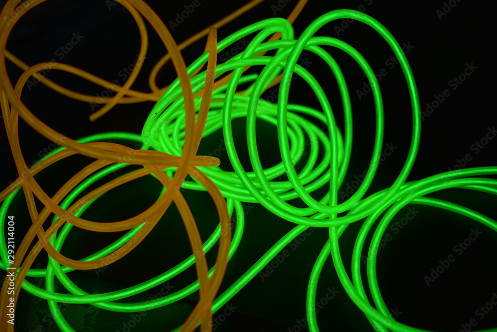 Bright luminous yellow and green, lime neon wires in different formats and layouts. An electroluminescent wire, a neon light guide, an ice tube are folded into different structures and shapes. Bright luminous yellow and green, lime neon wires in different formats and layouts. An electroluminescent wire, a neon light guide, an ice tube are folded into different structures and shapes.