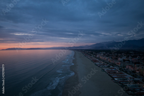 Aerial breathtaking sunset, view from a drone, sun going down in the horizon, amazing light