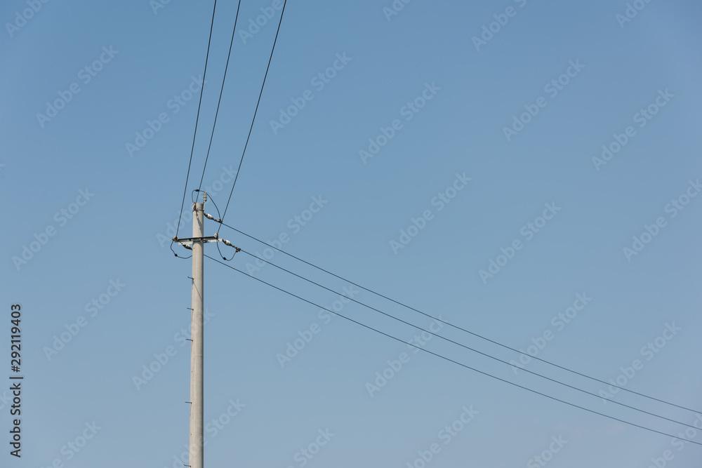 Close-up of concrete cement poles and wires against sky clouds background Close-up of concrete cement poles and wires against sky clouds background
