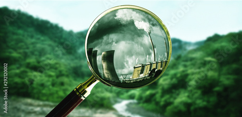 Foto Researching in the woods with a magnifying glass for the industry