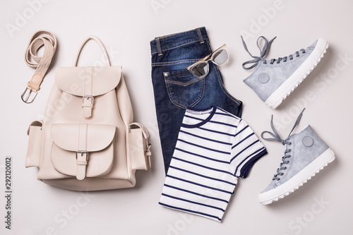 Clothing outfit - white backpack, jeans, striped t shirt, blue sneakers photo