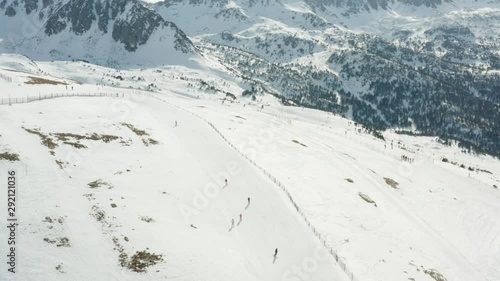 A group of skiiers on a piste in Andorra photo