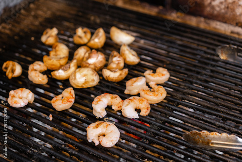 Delicious roasted shrimps on BBQ. The chef of the restaurant roasts on the coals