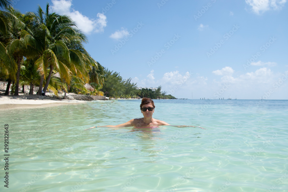 Woman with sunglasses bathing on the Caribbean beach - image