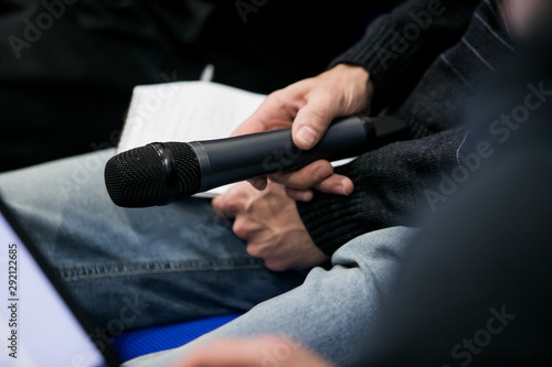 Foto Press officer of a company giving interview to journalist with a microphone