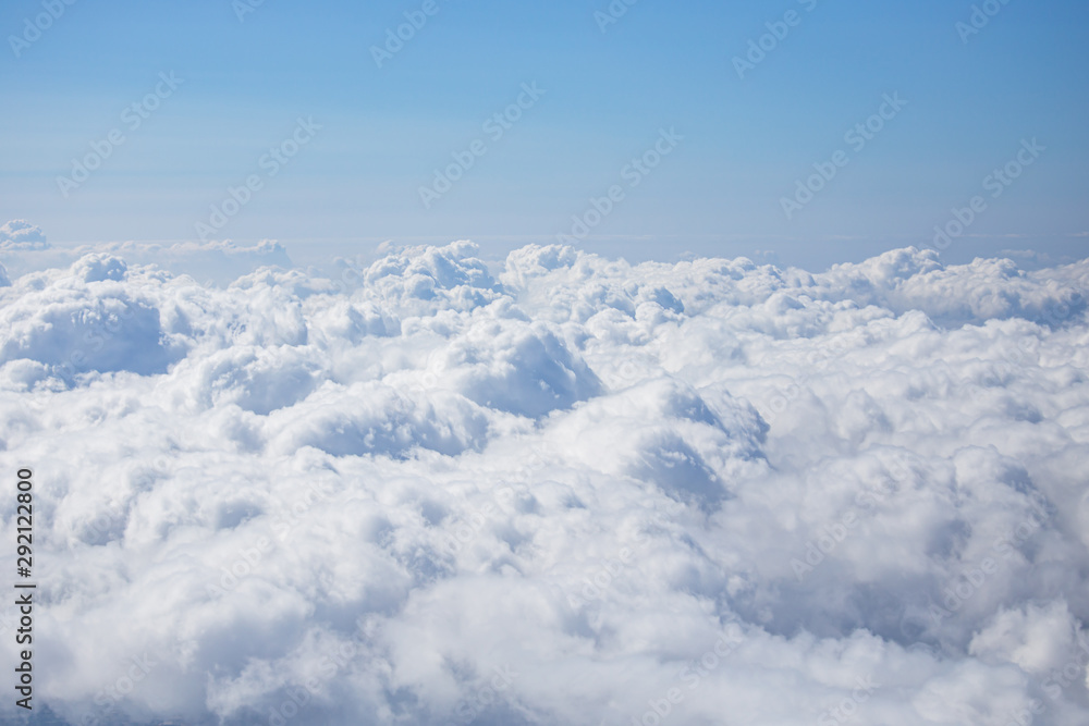 top view from airplane window of blue sky with cloudy background.