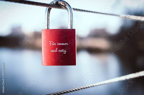 red padlock, love lock on a bridge
