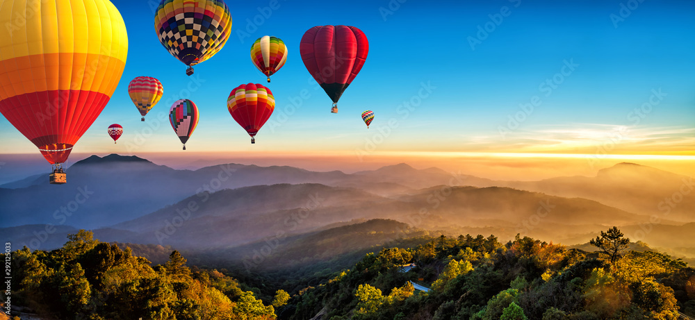 Hot air balloons flying over sea of mist awakening in a beautiful hills at sunrise in Chiang Mai, Thailand. - obrazy, fototapety, plakaty 