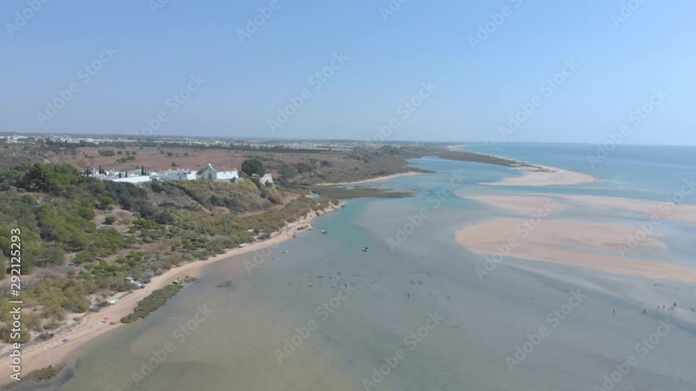 Aerial view of small village surrounded by beautiful bay where the river flows into the ocean.