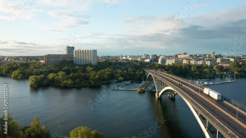 Aerial view Vasterbron bridge Stockholm Sweden, drone flies over traffic, water and cityscape photo