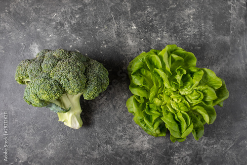 Fresh green vegetables on a dark background, top view with copy space.