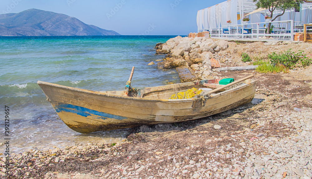 Old fishing boat on the beach with view at the sea.