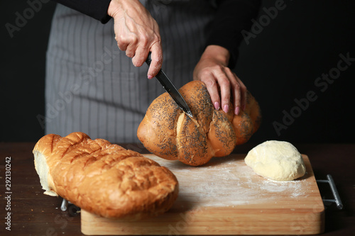 cooking fresh bread from flour on a table on a black background