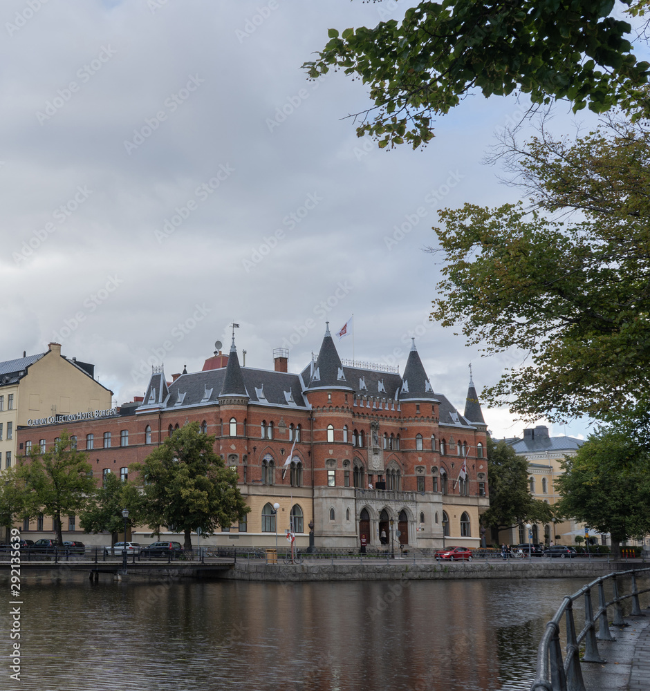 Sweden. Red brick building by the river. Cloudy day in Orebro. Travel photo. Sweden. Red brick building by the river. Cloudy day in Orebro. Travel photo.