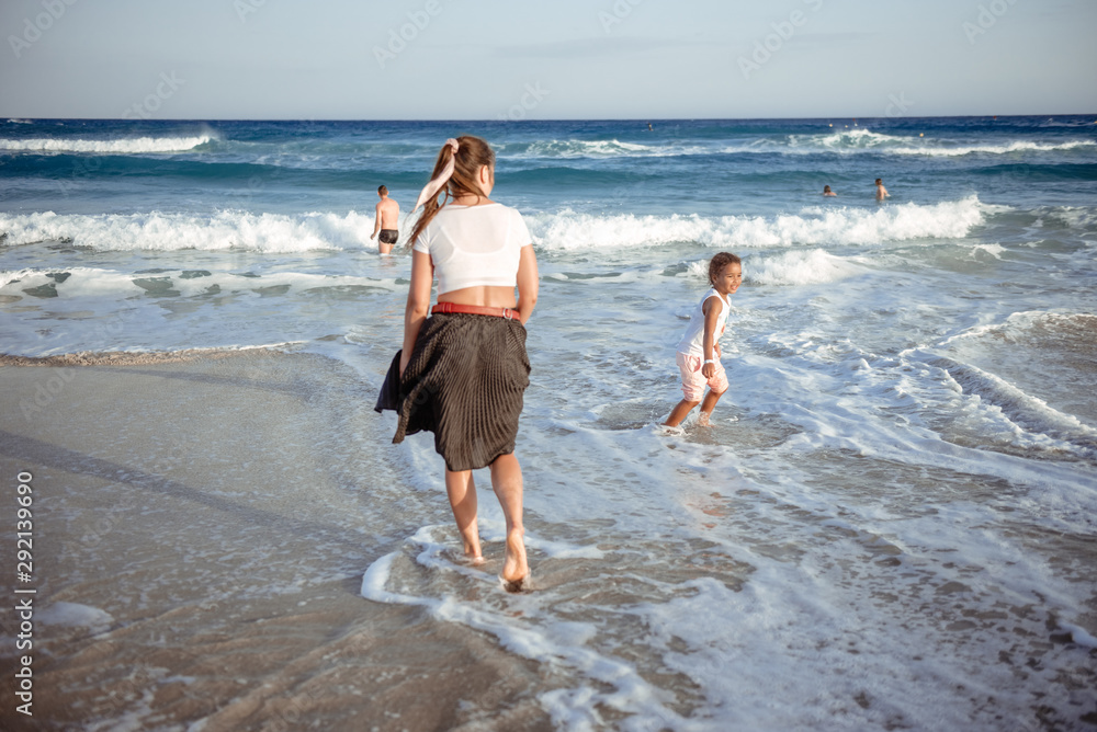 happy  little girl have fun and joy time at beautiful beach