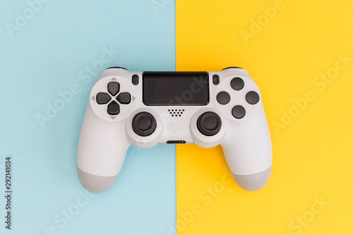Video games white gaming controller isolated on yellow blue color background top view