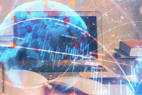 Financial graph colorful drawing and table with computer on background. Double exposure. Concept of international markets.