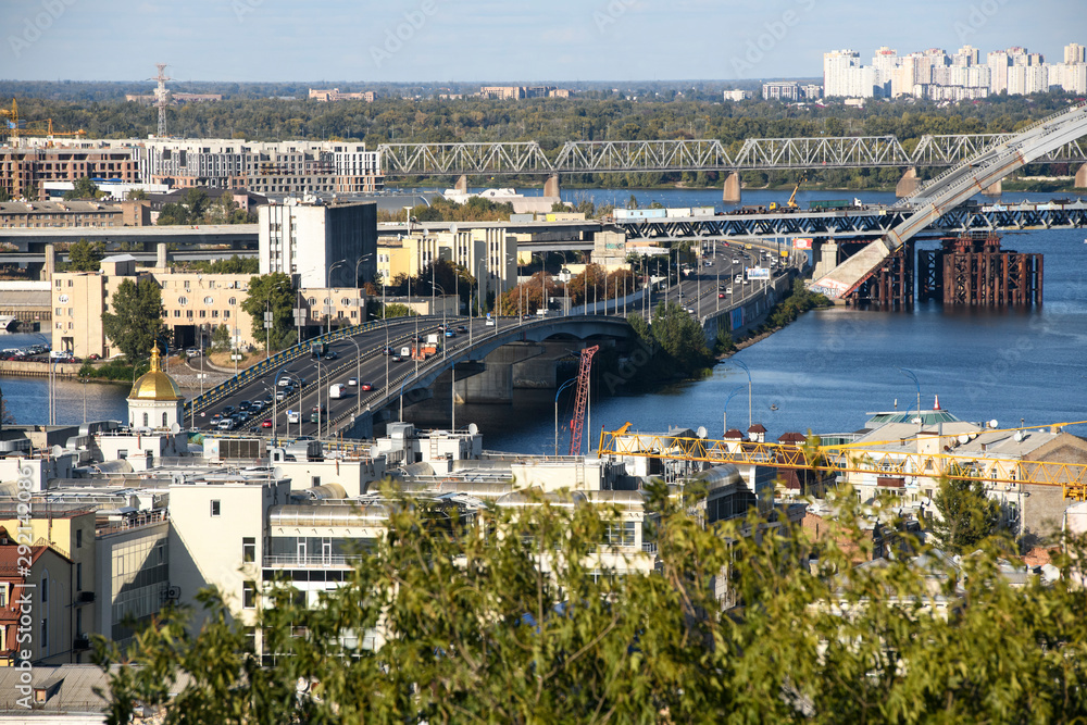 View of the old Podil district of the city of Kyiv and Dnipro River Dnieper with various bridges. Ukraine, September 2019