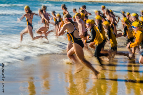 Fotografija Nippers competitors running into the ocean in surf lifesaving beach swimming eve