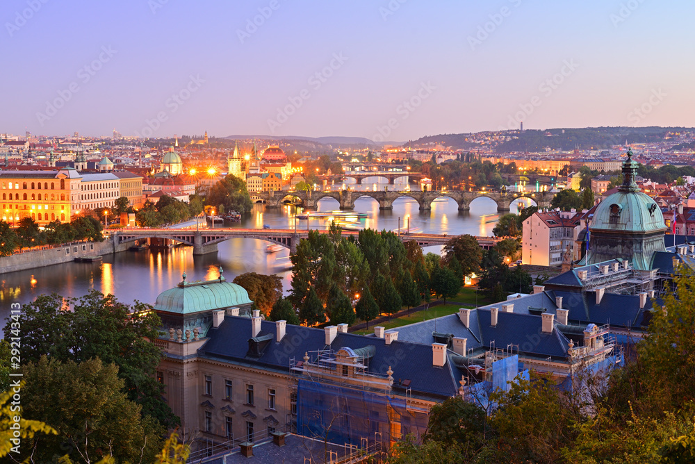 Evening view over bridges on Vltava river and historical part of Prague, Czech Republic.