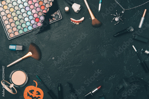 Photo of shadows, brushes, halloween spider, ghost on empty black background