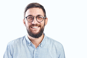 Portrait of an authentic smiling young bearded brunette man with glasses on a white background