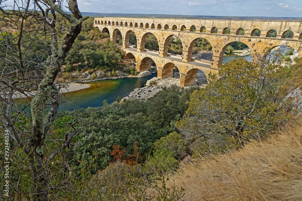 REMOULINS, FRANCE, SEPTEMBER 20, 2019 : The Pont du Gard, the highest Roman aqueduct bridge, and one of the most preserved, was built in the 1st century, added to list of World Heritage Sites in 1985.