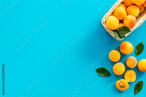 Collect apricots  blue background top view space for text  pattern with leaves