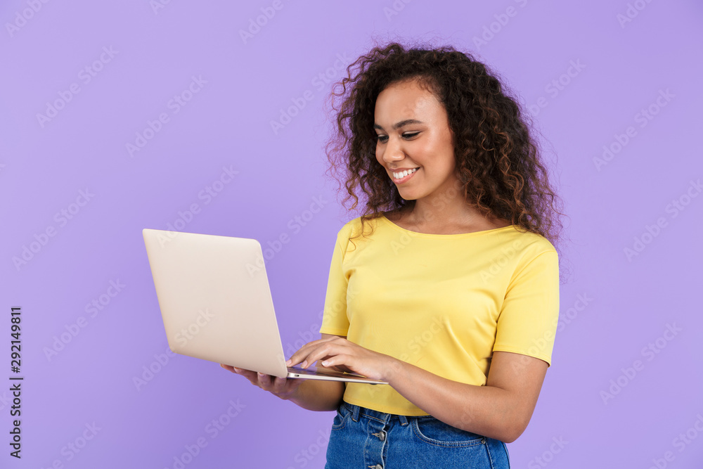 Image of beautiful african american woman holding laptop computer Image of beautiful african american woman holding laptop computer