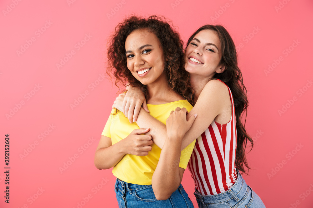 Image of seductive multinational girls hugging and smiling together Image of seductive multinational girls hugging and smiling together