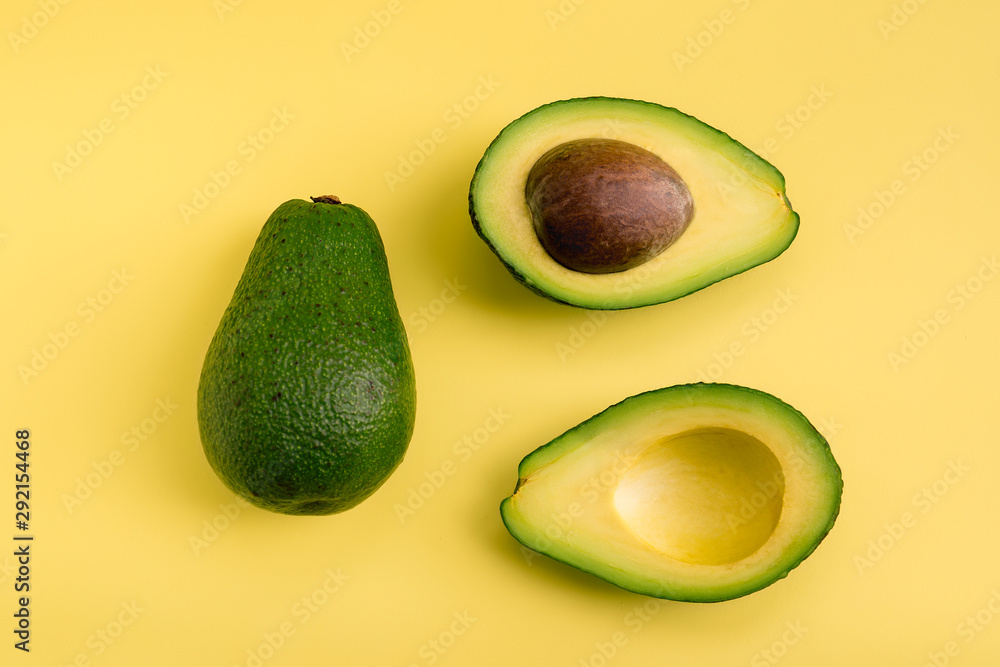 Avocado flat lay on yellow background. Simple and minimal concept. Organic healthy food. Top view