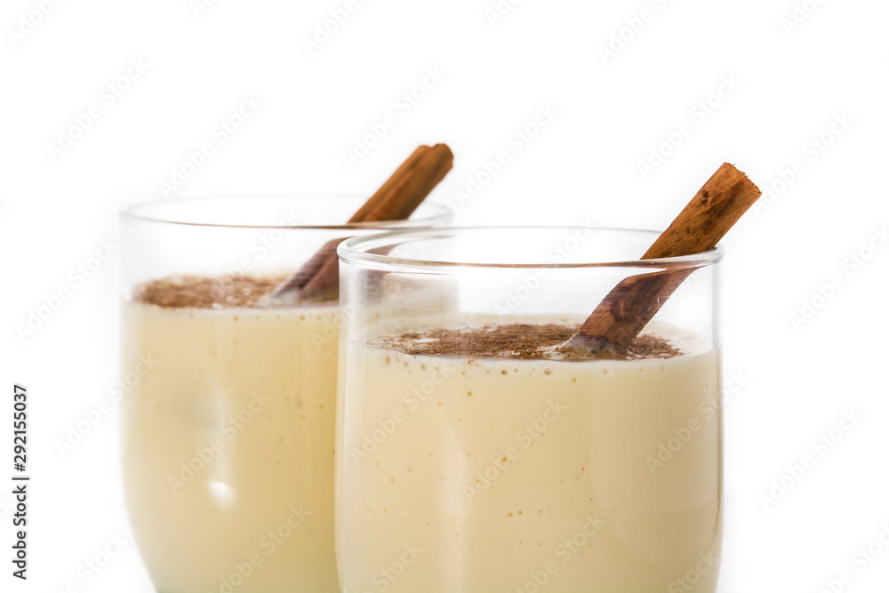 Homemade eggnog with cinnamon in glass isolated on white background. Typical Christmas dessert. Homemade eggnog with cinnamon in glass isolated on white background. Typical Christmas dessert.