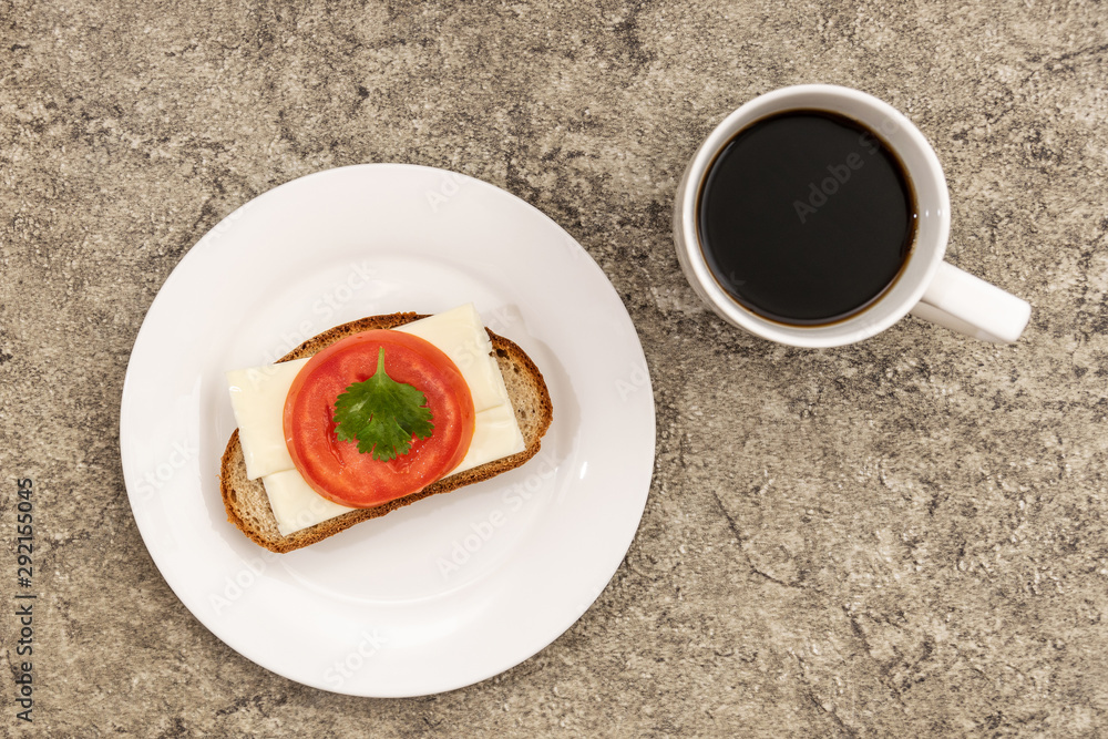 Bread with cheese and tomato. Near a cup of coffee. Bread with cheese and tomato. Near a cup of coffee.