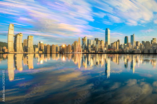 Chongqing skyline and modern urban skyscrapers with water reflection landscape at sunset China.