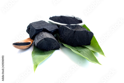 Detox activated charcoal black  on white background, with leaves and lemon