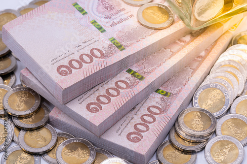 Slika na platnu Thai baht banknotes and coins. Savings and investing concept